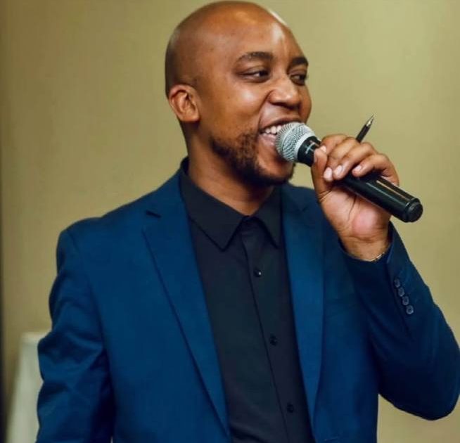 Shozi The MCee in a blue suit, portrait photo